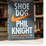 Cover of the book 'Shoe Dog' by Phil Knight with Nike logo.
